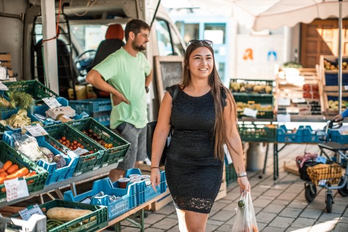 Eine Kundin schlendert über den Wochenmarkt. Foto: Daniel Nasse